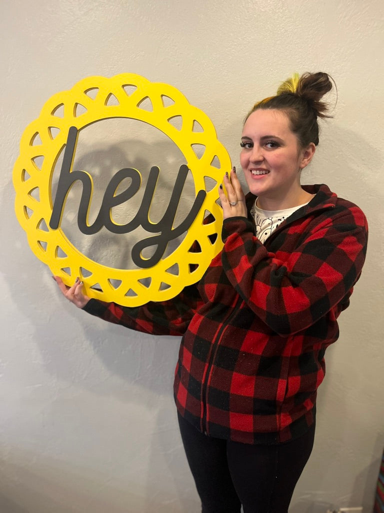 Contemporary 'Hey' Circular Door Hanger – Chic Silver Lettering on Vibrant Wooden Sign